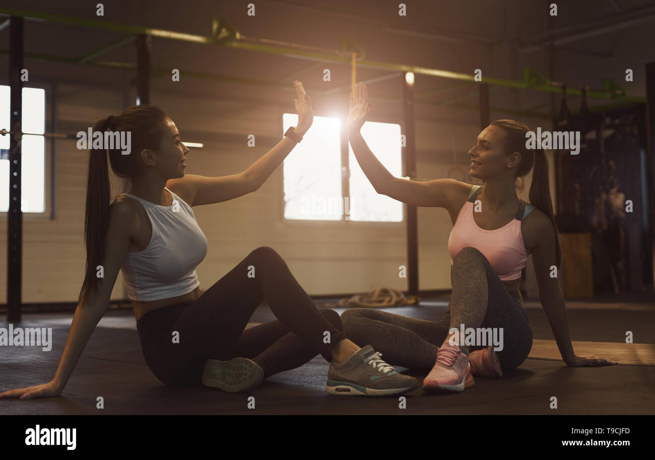 Successful training. Women giving high five, having rest Stock Photo