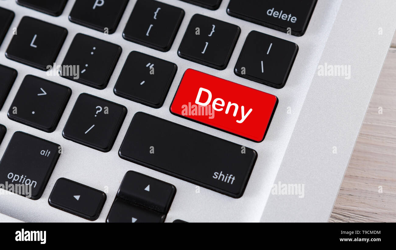 Red computer button on keyboard with text Deny Stock Photo