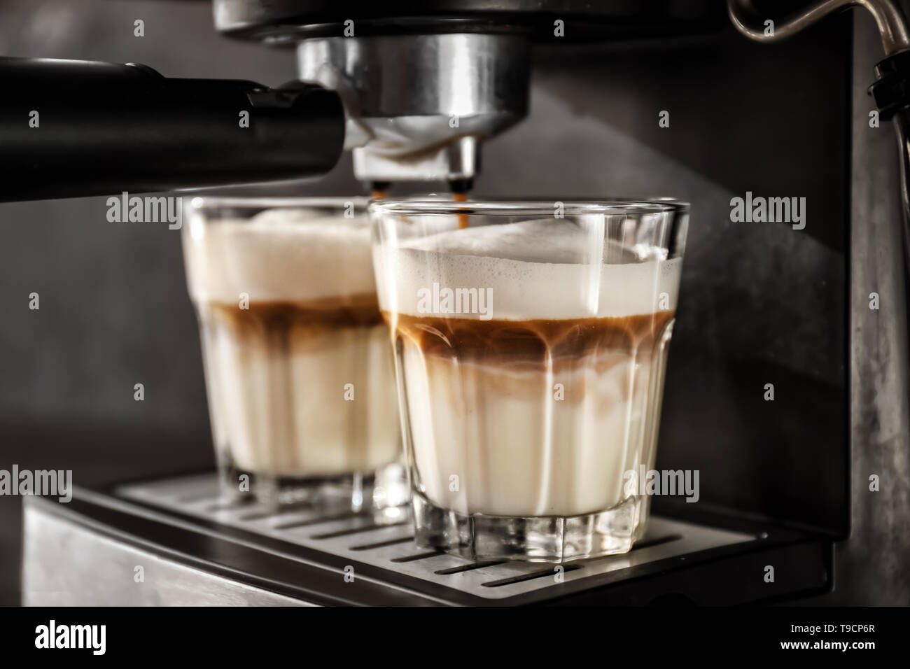 Coffee machine making latte, closeup Stock Photo Alamy