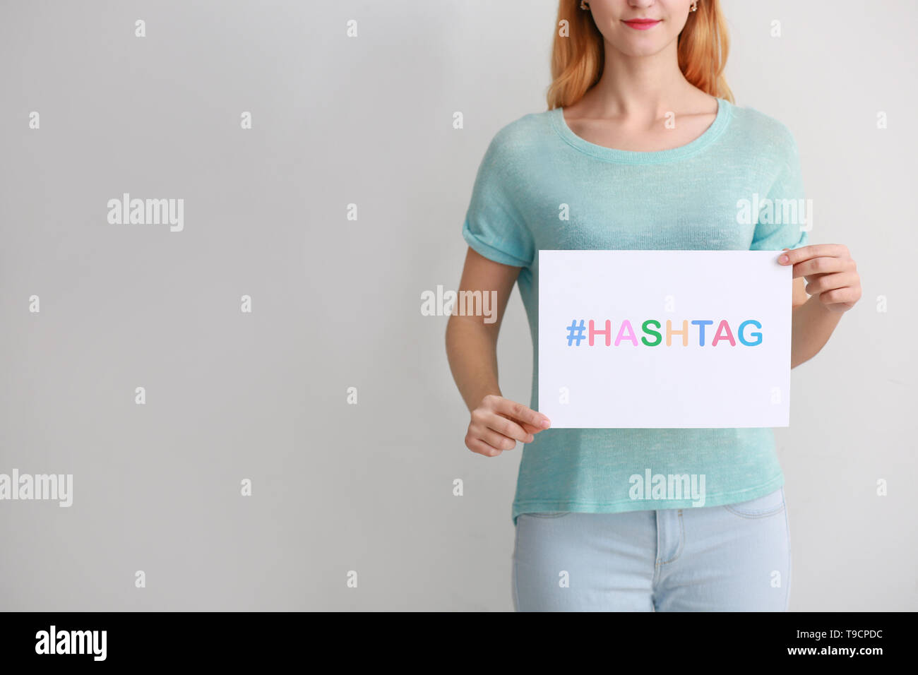 Hashtag Paper Woman holding sheet of paper with hashtag on light background Stock ...