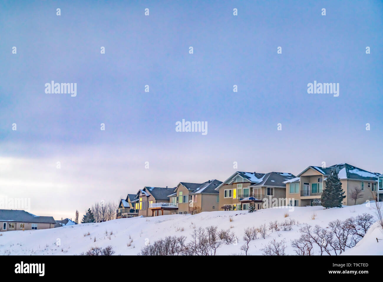 Residences built on a frosted mountain overlooking a vast sky with ...