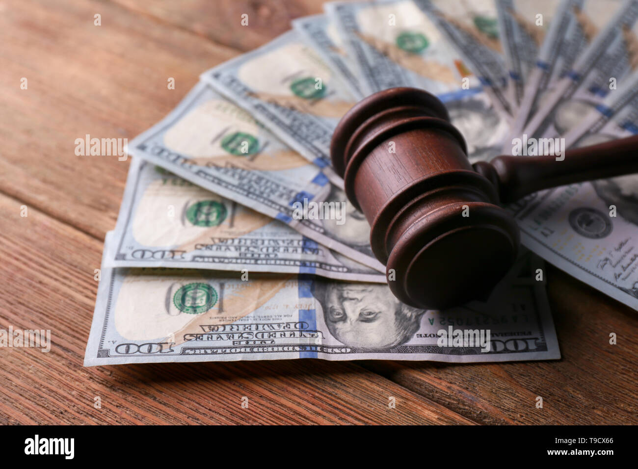 Judge's gavel with dollar banknotes on wooden table. Corruption concept ...
