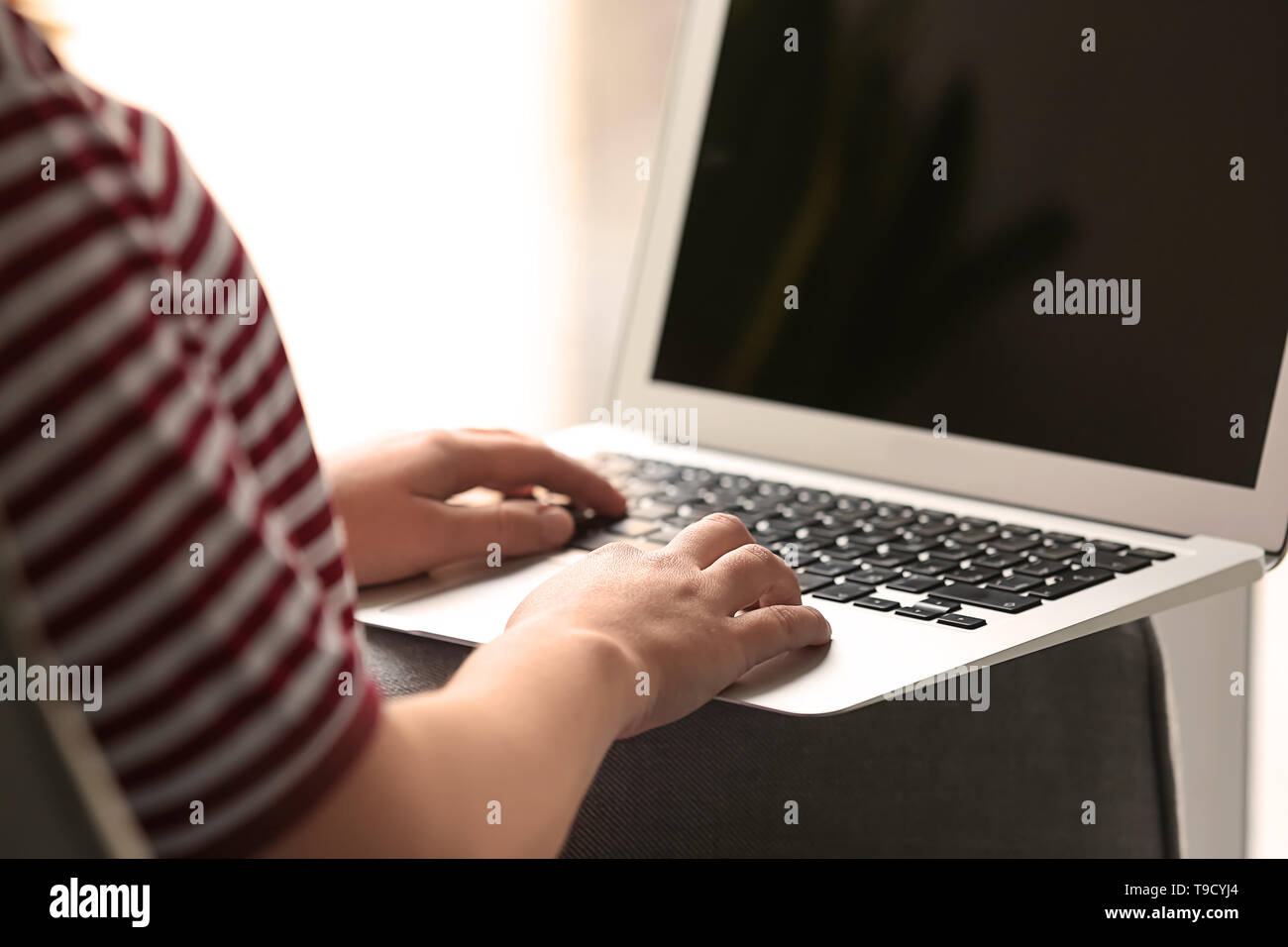 Woman with computer at home Stock Photo - Alamy