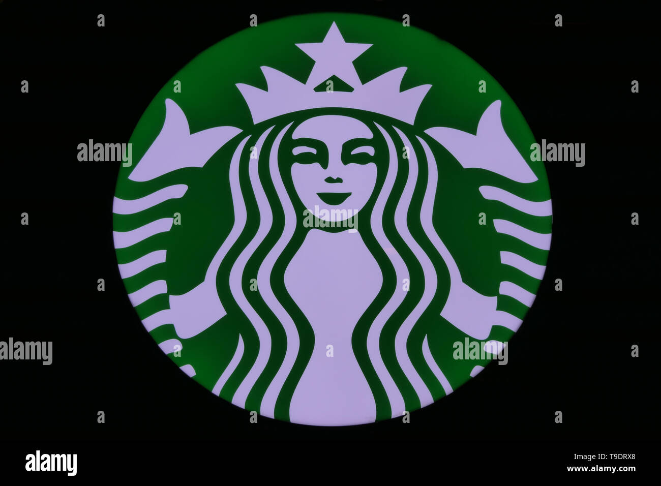 RIYADH, SAUDI ARABIA - DECEMBER 17, 2018: The official Starbucks Logo, with a black background Stock Photo