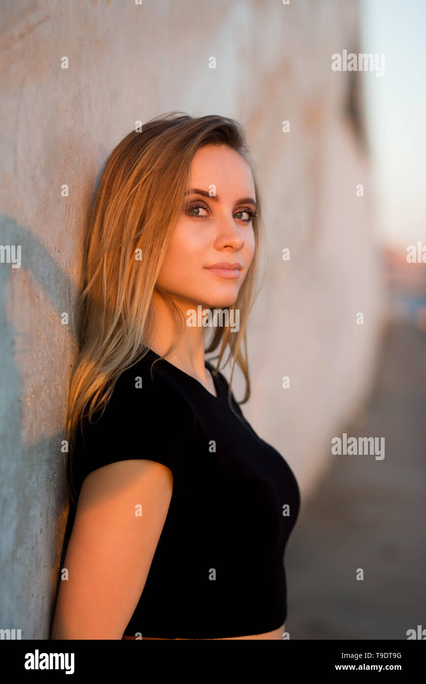 Close up of a portrait of a beautiful blonde woman looking at the ...