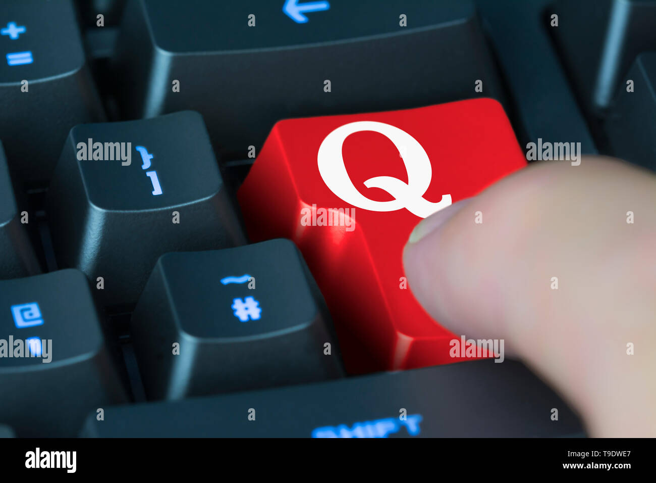 Finger pressing button on a computer keyboard to load the Quora app or website, a website for online knowledge sharing. Stock Photo