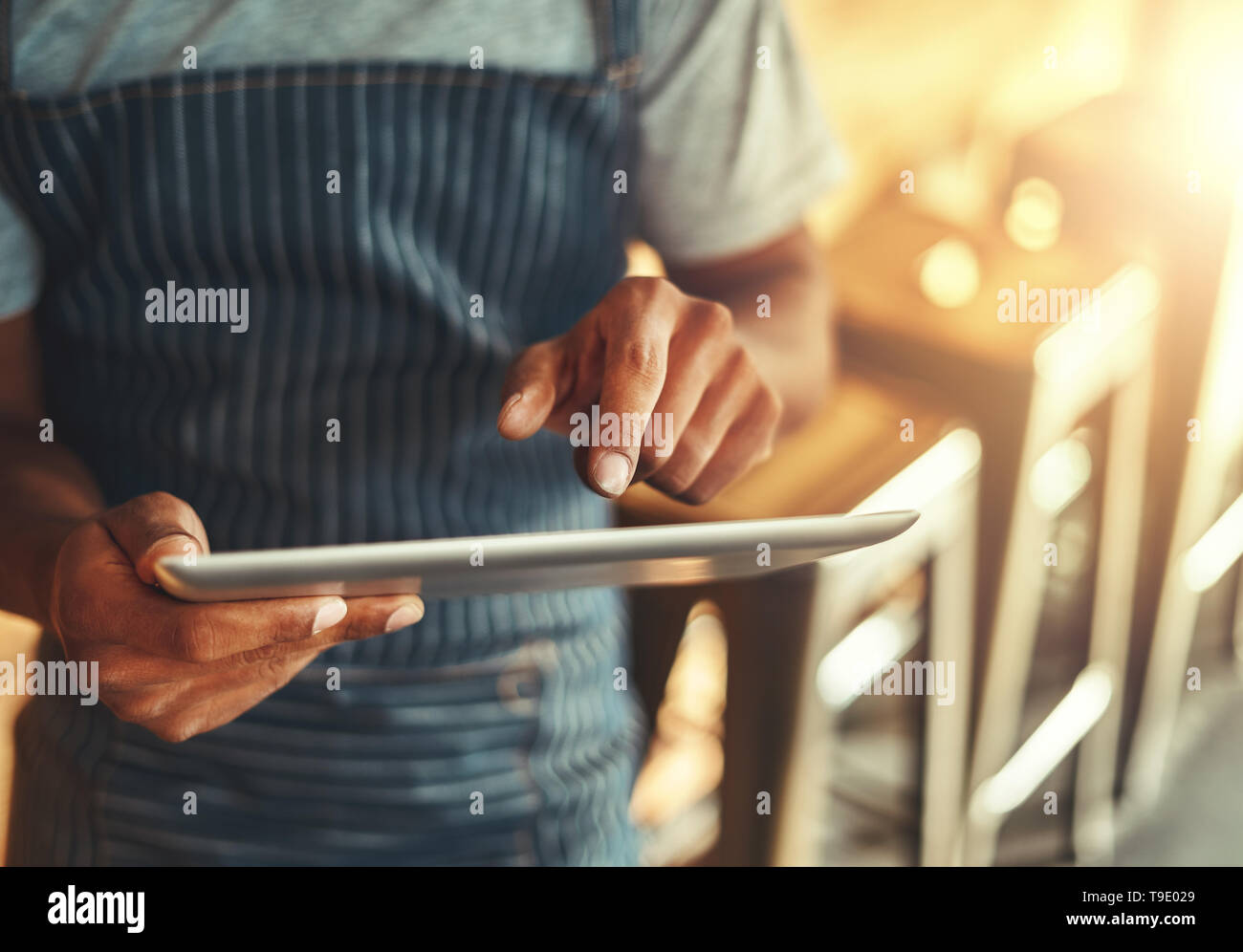 Cafe owner using digital tablet Stock Photo