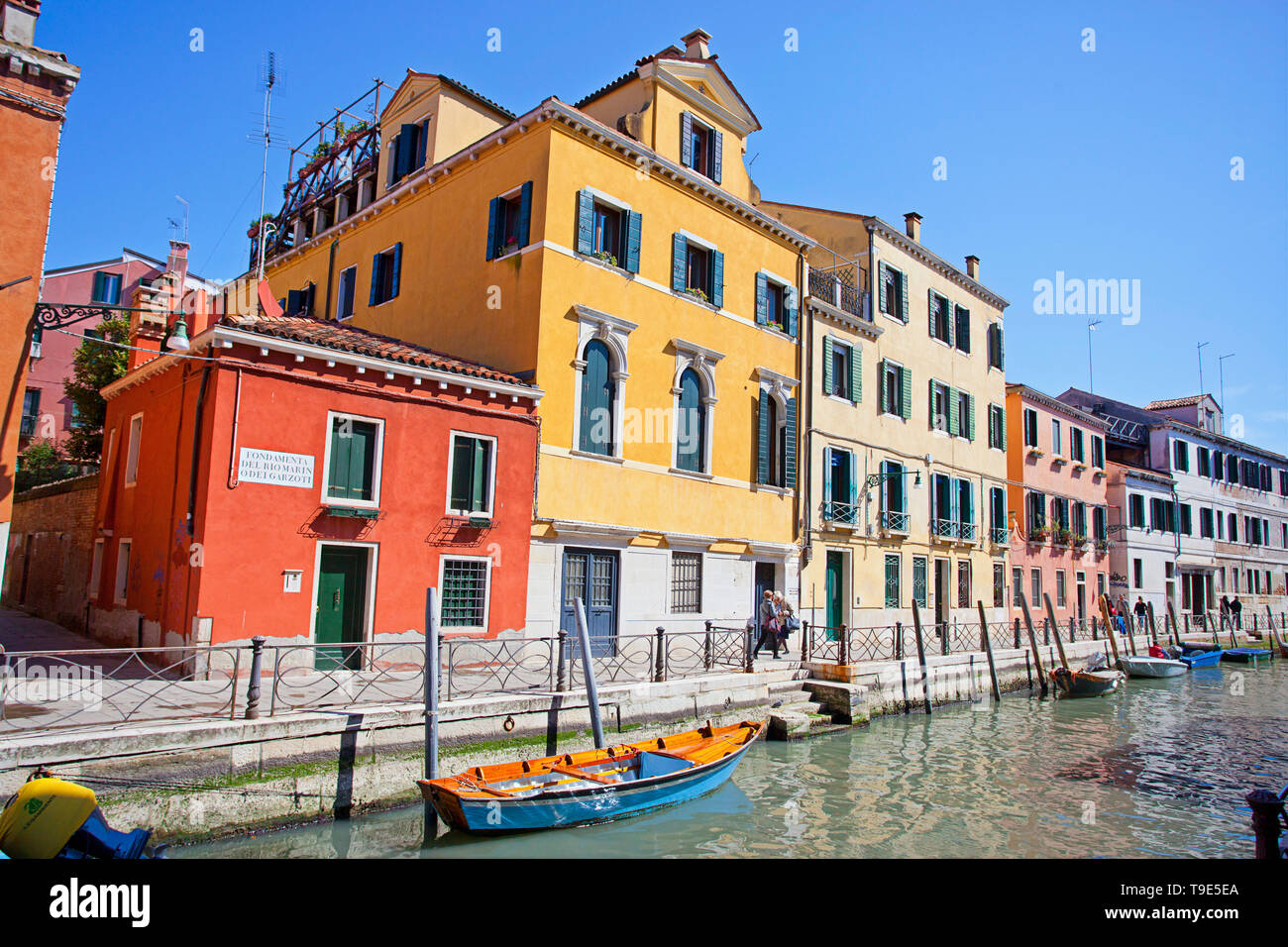 Boats along a canal in Venice. Stock Photo