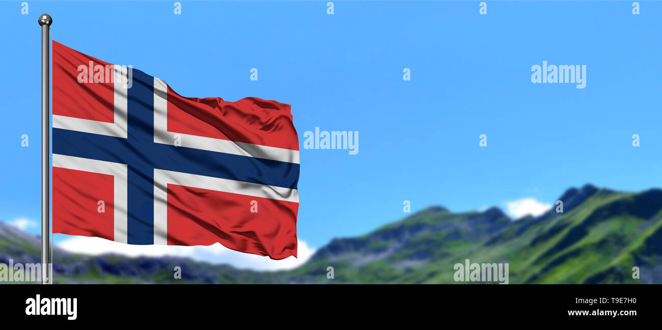 Norway flag waving in the blue sky with green fields at mountain peak ...