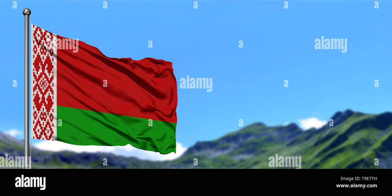 Belarus flag waving in the blue sky with green fields at mountain peak background. Nature theme. Stock Photo