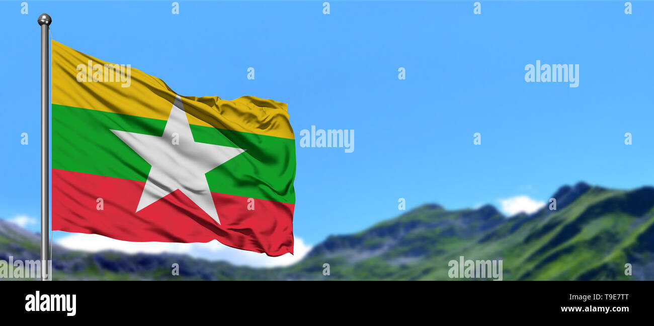 Myanmar flag waving in the blue sky with green fields at mountain peak ...