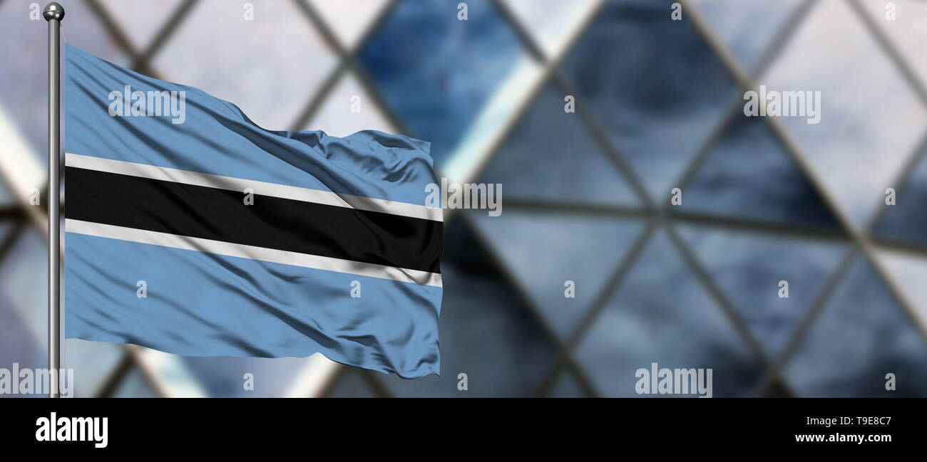 Botswana flag waving in the wind against blurred modern building ...