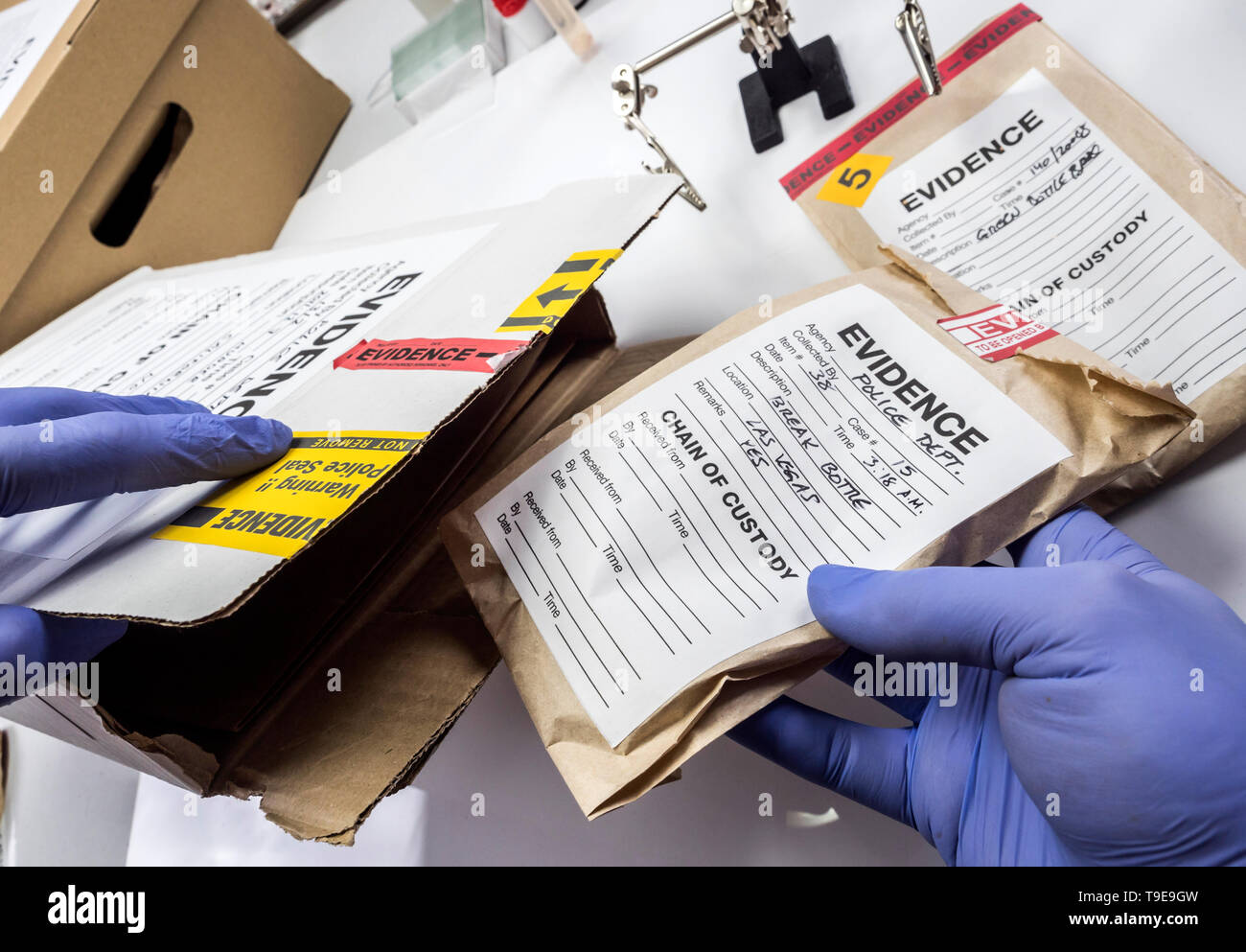 Police expert saved in a box records and evidence of a case of murder in the laboratory scientist Stock Photo