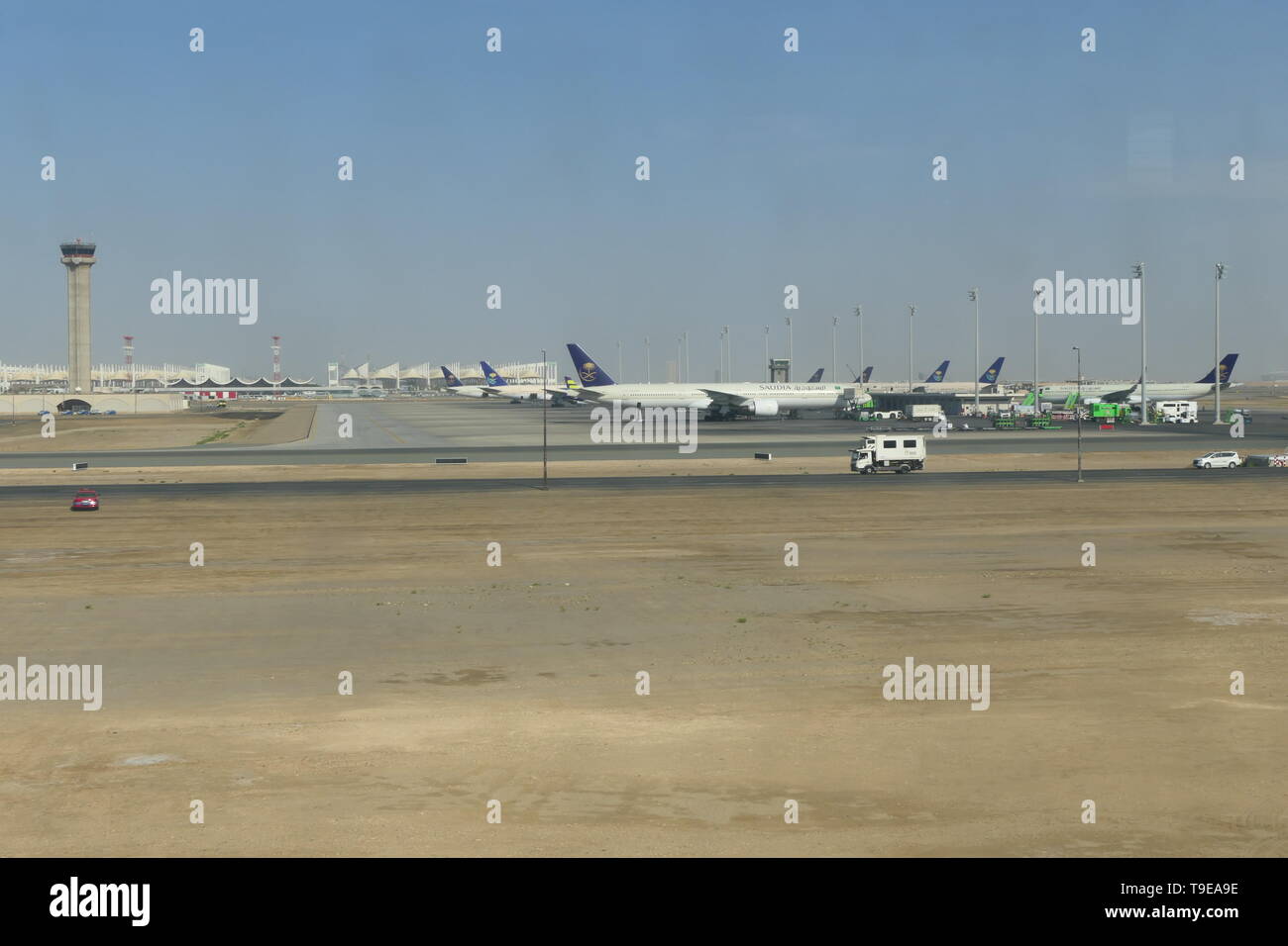 JEDDAH, SAUDI ARABIA - DECEMBER 22, 2018: View over the rollfield of the King Abdulaziz International Airport with SAUDIA Airplanes in the background Stock Photo