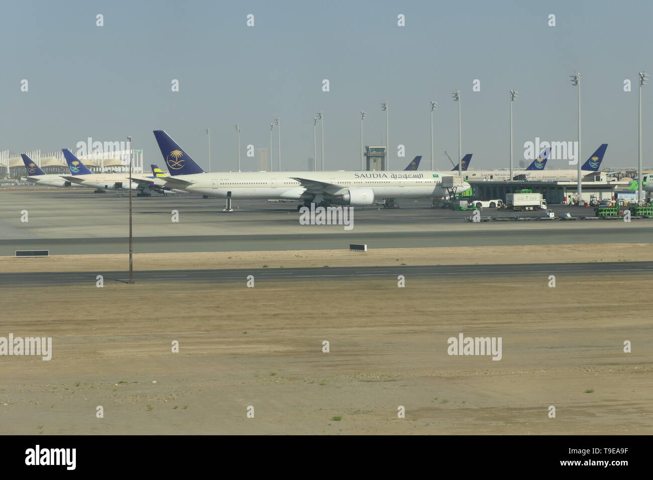 JEDDAH, SAUDI ARABIA - DECEMBER 22, 2018: View over the rollfield of the King Abdulaziz International Airport with SAUDIA Airplanes in the background Stock Photo