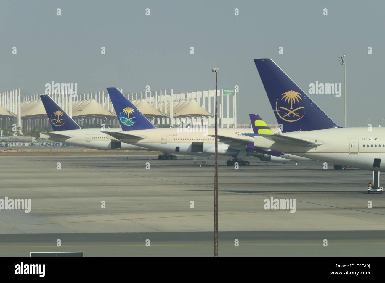 JEDDAH, SAUDI ARABIA - DECEMBER 22, 2018: Three SAUDIA Airplanes on the King Abdulaziz International Airport Stock Photo