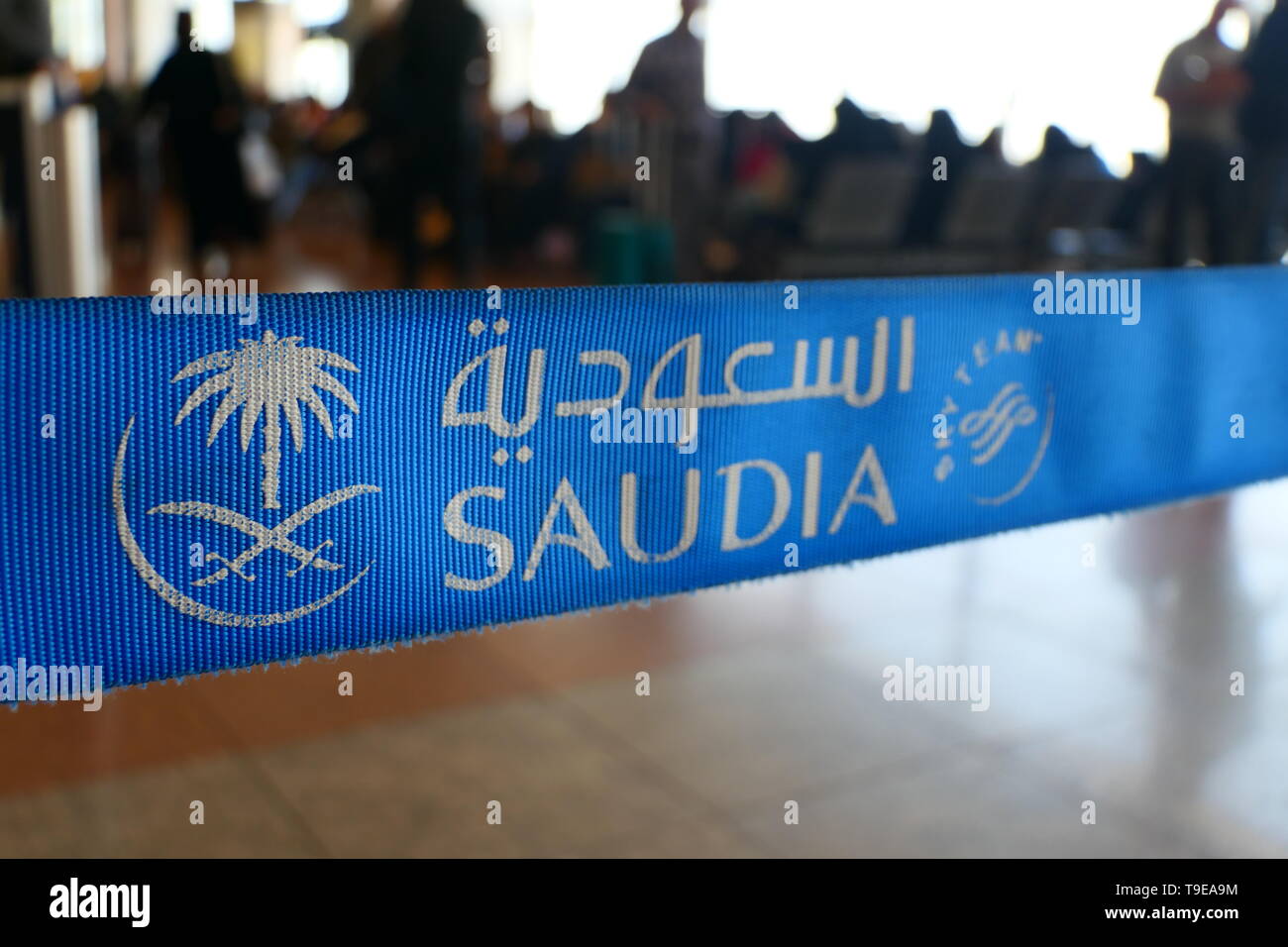 JEDDAH, SAUDI ARABIA - DECEMBER 22, 2018: A close-up view of the Logo of SAUDIA on a demarcation stand within the Jeddah International Airport Stock Photo