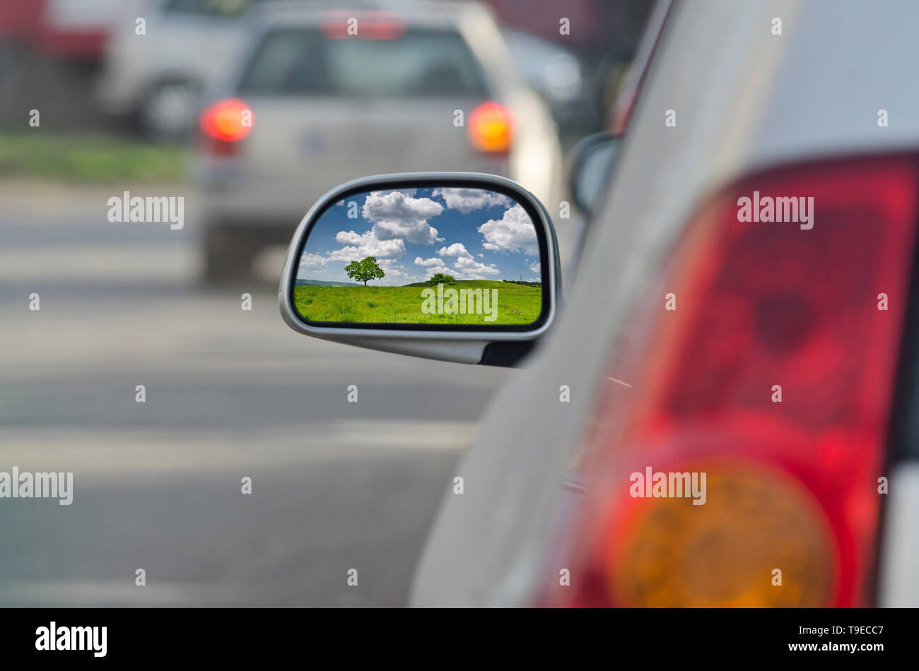 Looking in the side rear-view mirror during the traffic jam Stock Photo