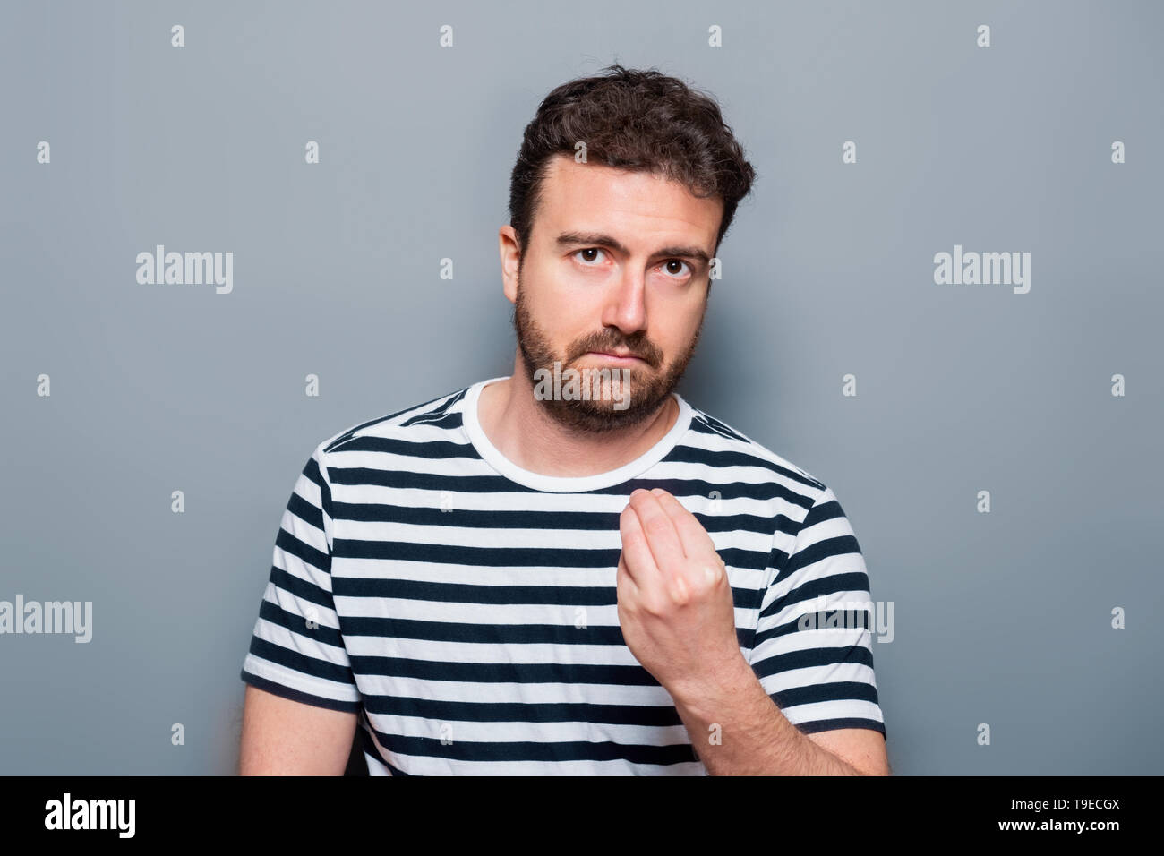 Studio portrait of doubtful caucasian male Stock Photo - Alamy