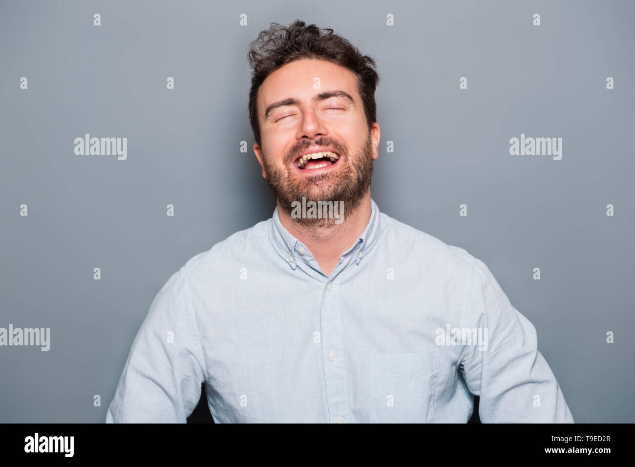 Studio portrait of laughing out loud caucasian male Stock Photo - Alamy