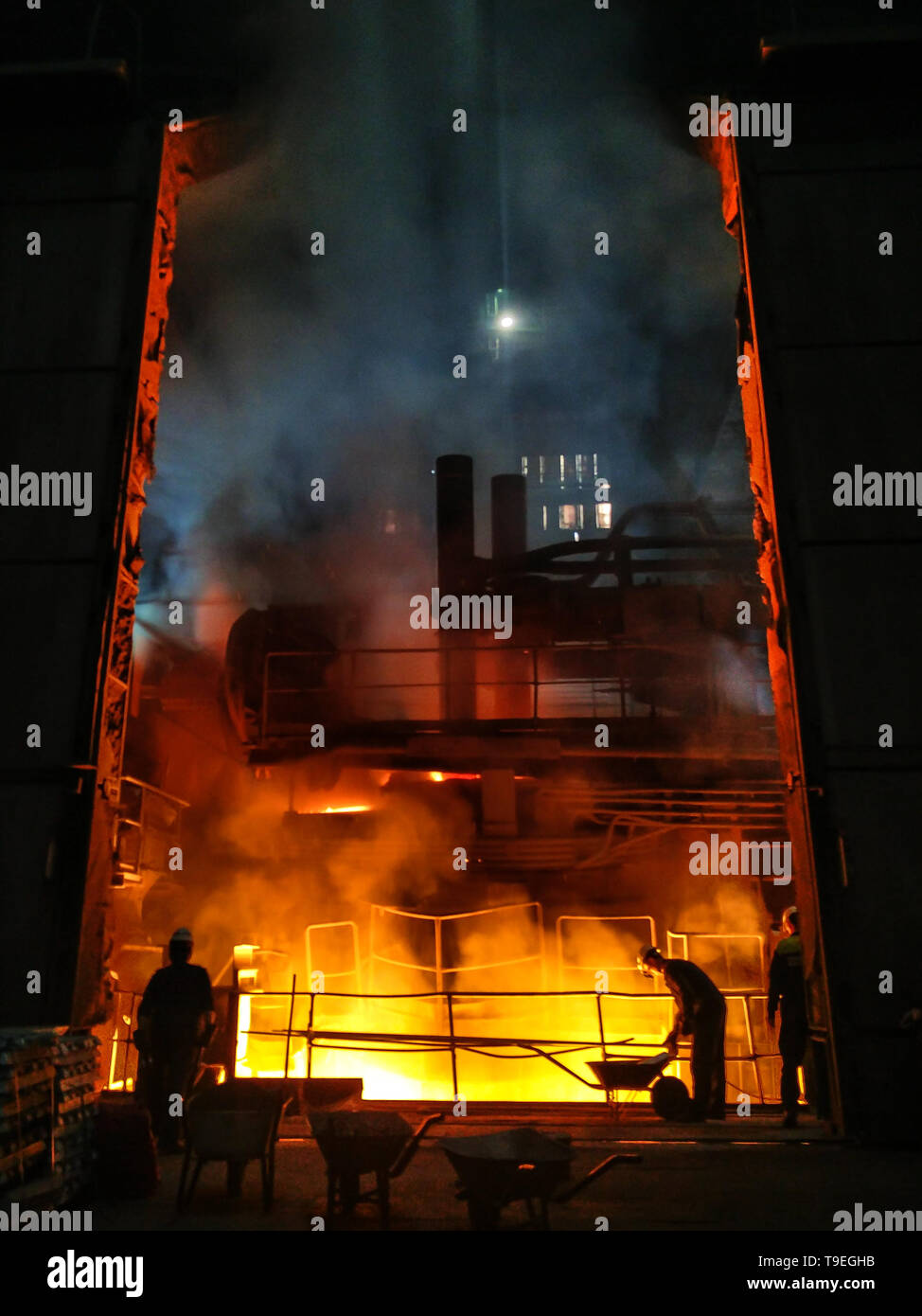 Smelting of metal in big foundry. Iron and steel production at a