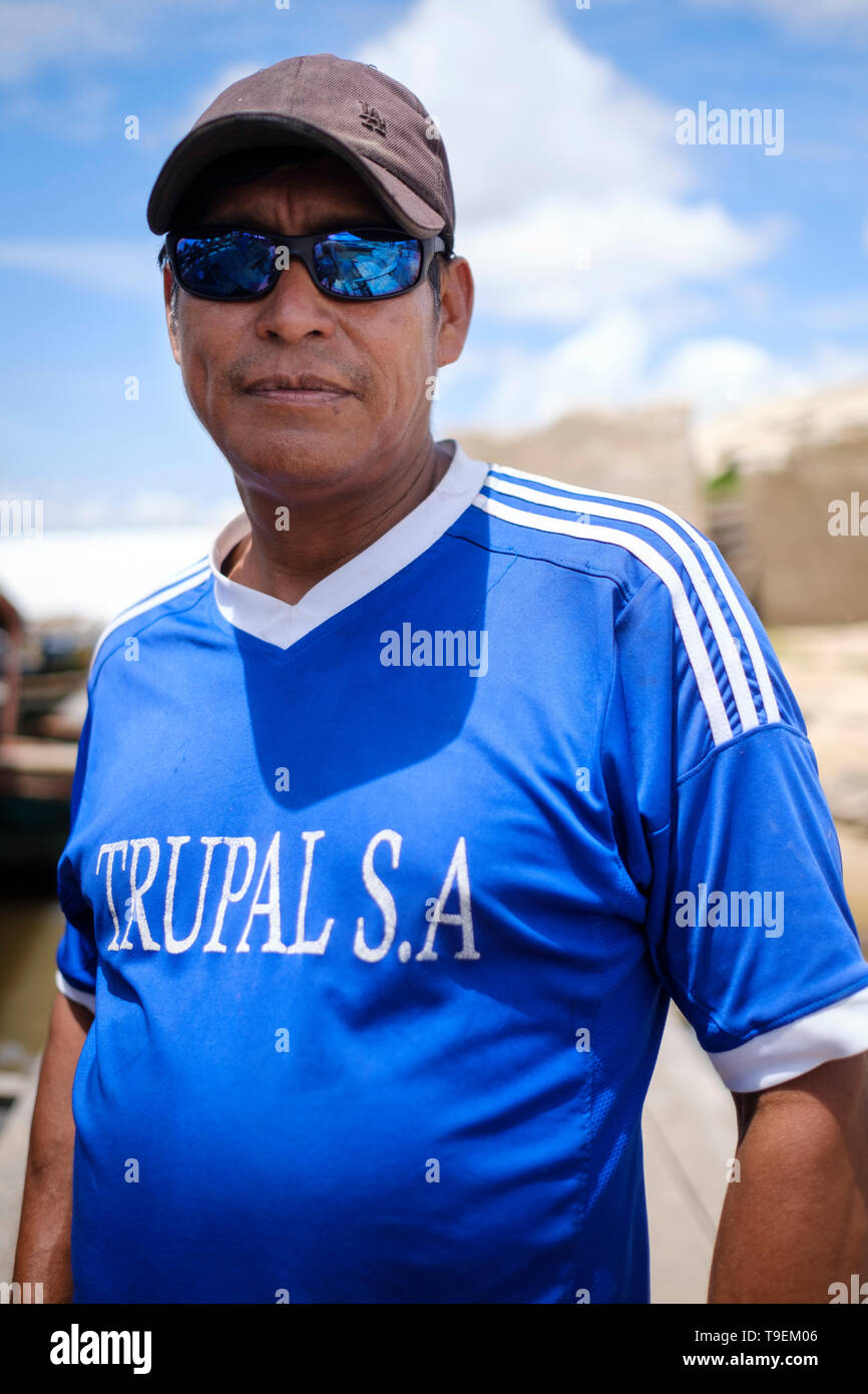 Portrait of local man wearing sunglasses and a cap on Bellavista Nanay River Port, Peruvian Amazon, Iquitos, Maynas Province, Loreto Department, Peru Stock Photo
