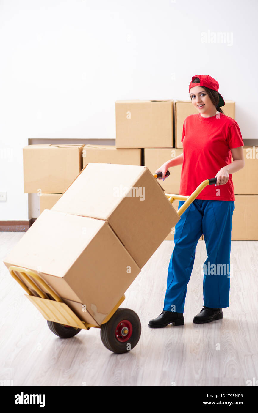 Young female professional mover doing home relocation Stock Photo