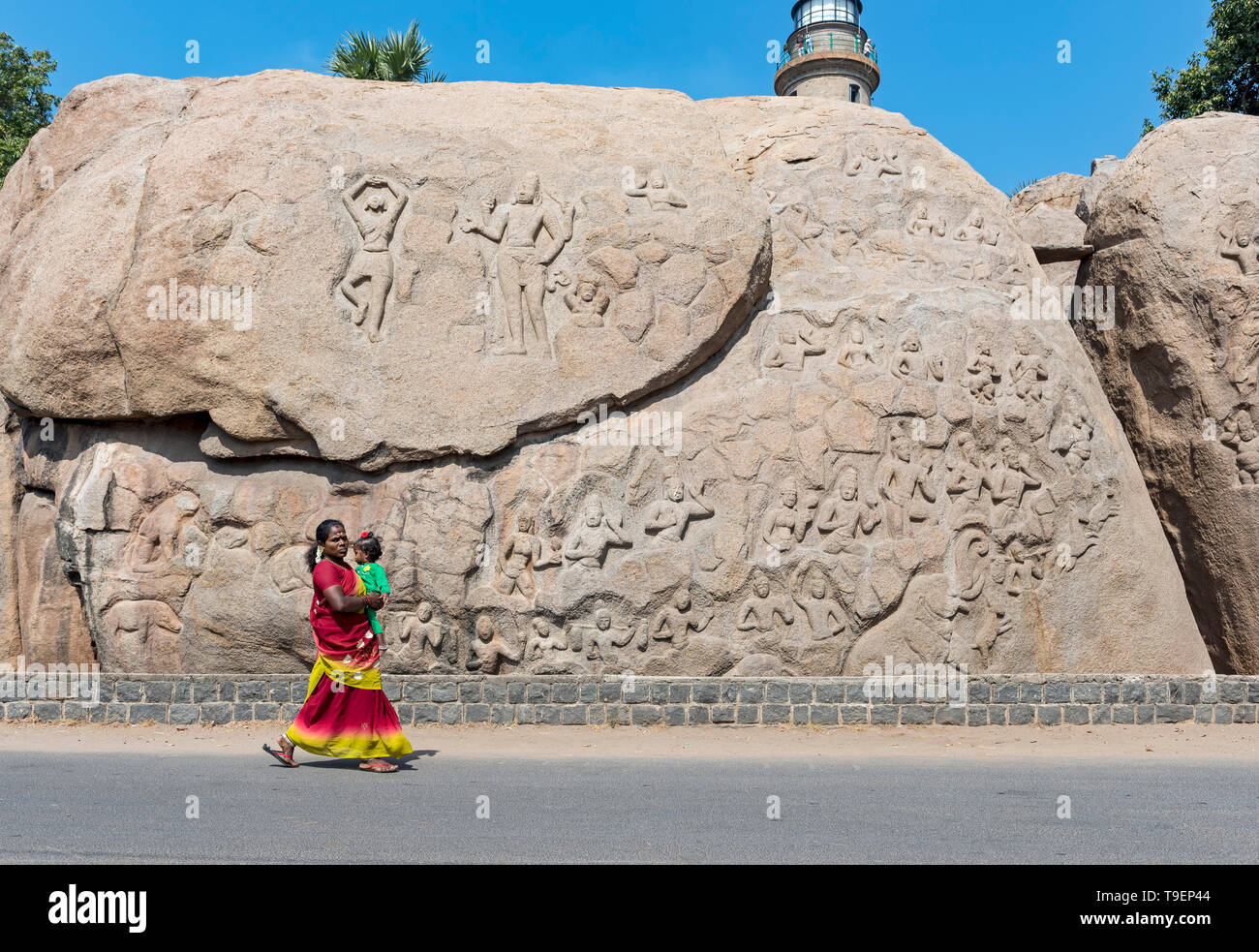 Woman with baby in front of Unfinished Relief Carving, Mahabalipuram (Mamallapuram), India Stock Photo