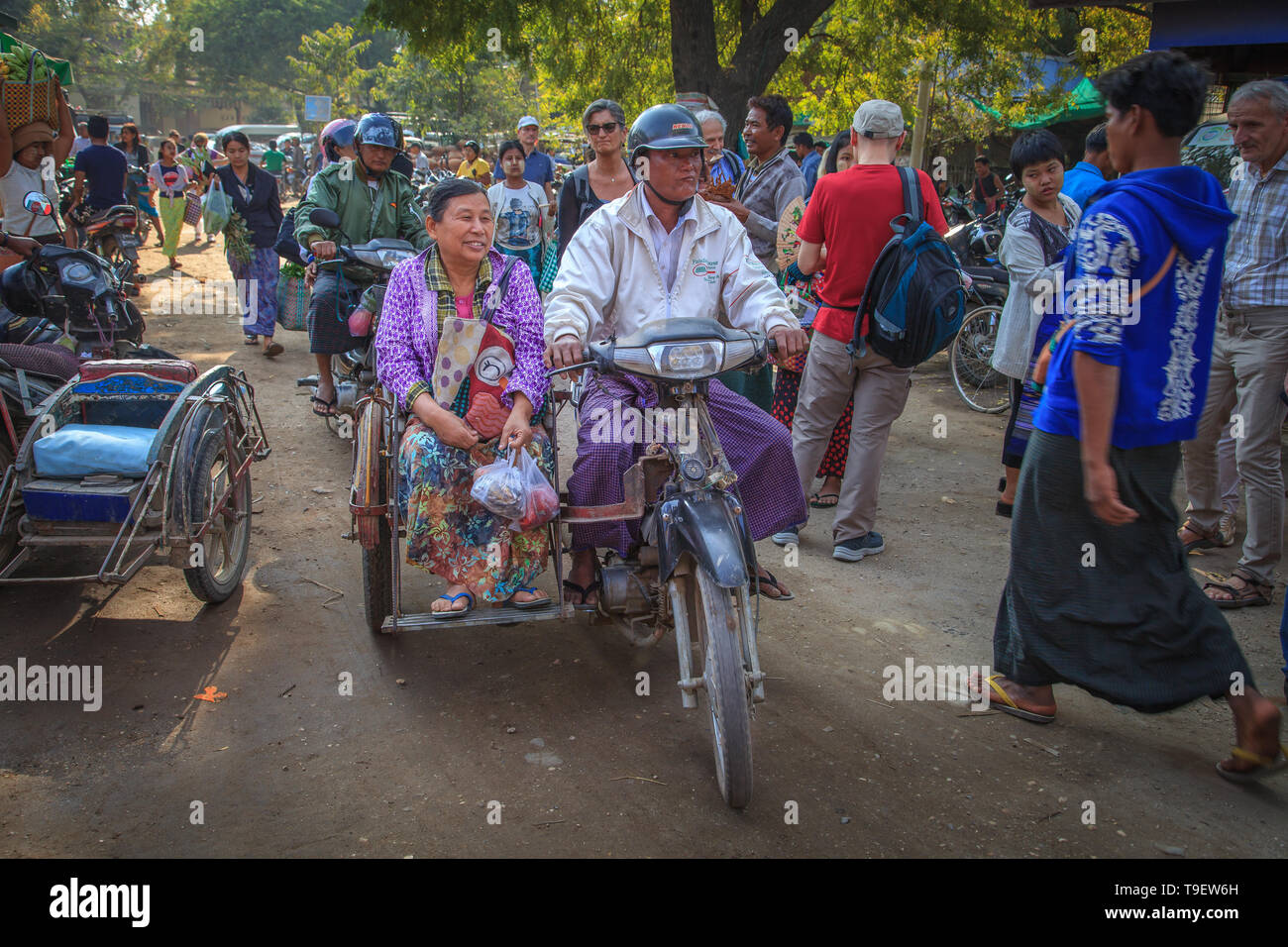 A burmese couple on the sidecar in Bagan Stock Photo