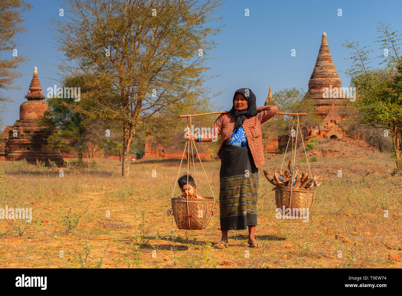 Burmese woman carrying her baby in a basket Stock Photo