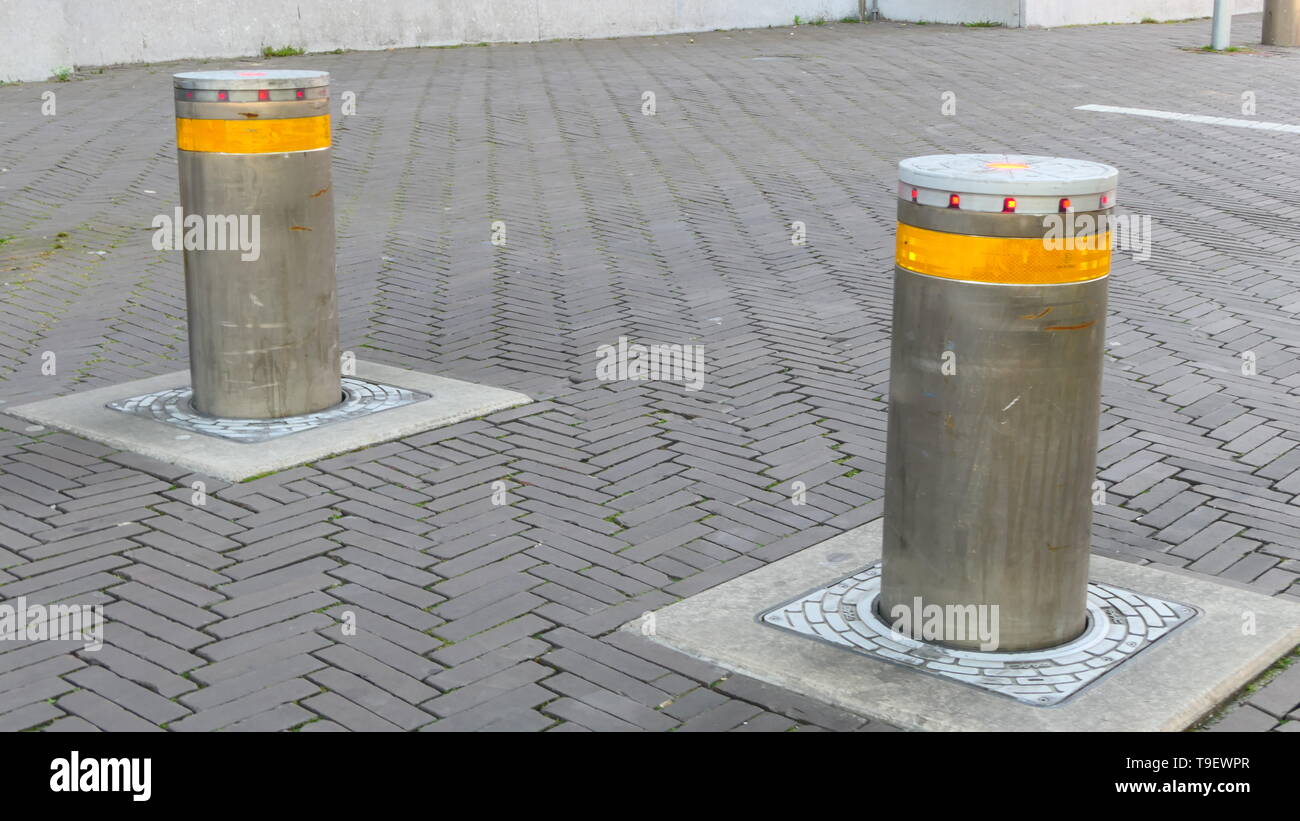 Two steel bollards within the pedestrian zone in the City of the Hague, to protect civilians against cars and terrorism Stock Photo