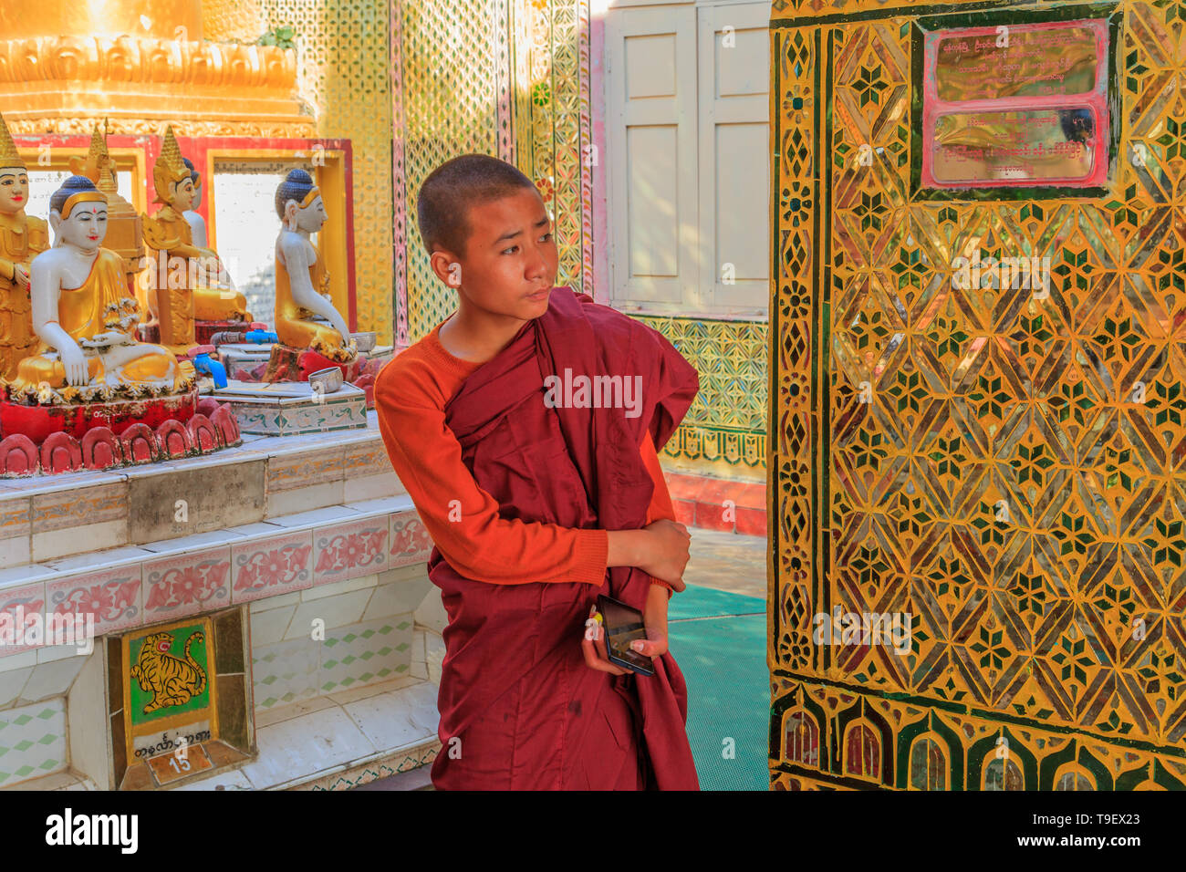 Monk visiting the Su Taung Pyae Pagoda in Mandalay Stock Photo