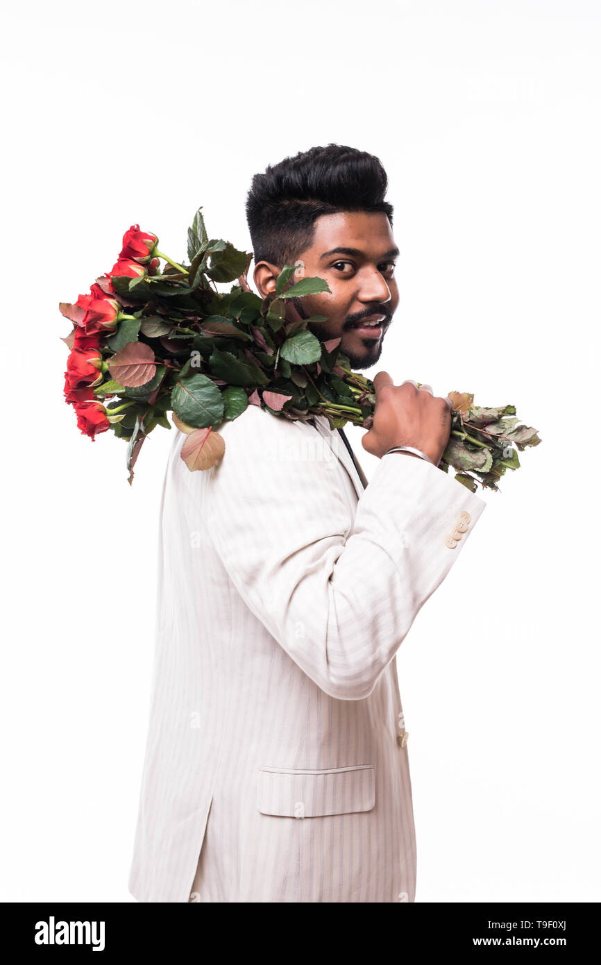 handsome man holding bouquet of red roses, isolated on grey Stock Photo ...