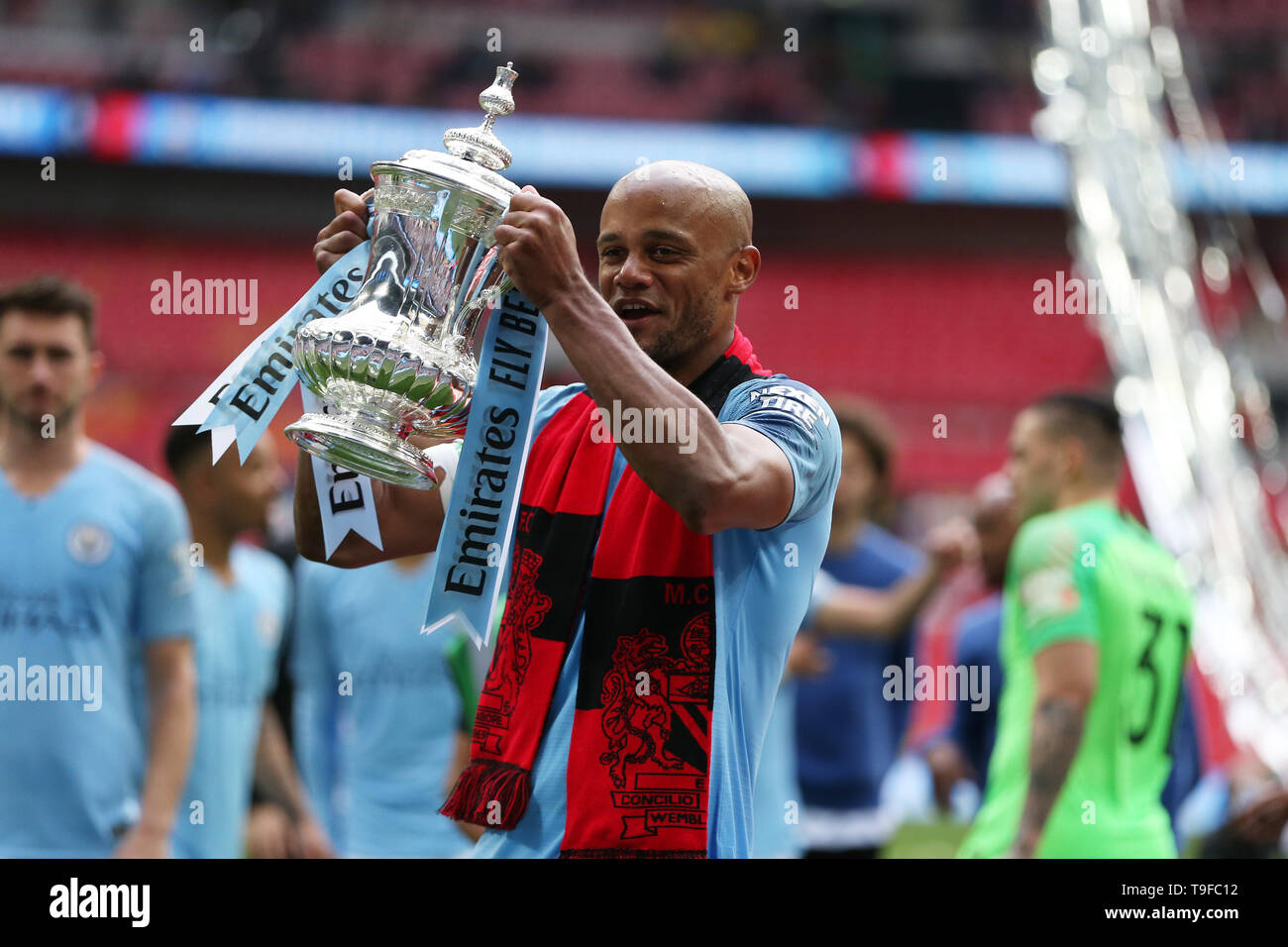 Vincent Kompany of Manchester city lifts the FA Cup trophy after the match