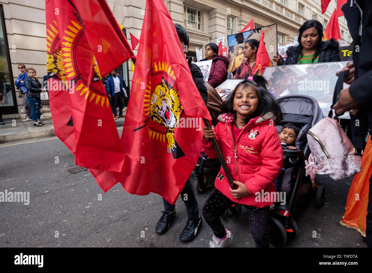 London, UK. 18th May 2019. A young girl holds a Tamil Eelam flag at the front of the march by several thousand Tamils, through London on Mullivaikkal Remembrance Day in memory of those killed by Sri Lanka’s genocidal war against the Tamils, which ended ten years ago. They call for a political solution which gives Tamils back control of their homeland of Tamil Eelam, and for an end to the ban on the Tamil Tigers. Public commemorations of the many thousands of war dead are forbidden in Sri Lanka. Peter Marshall/Alamy Live News Stock Photo