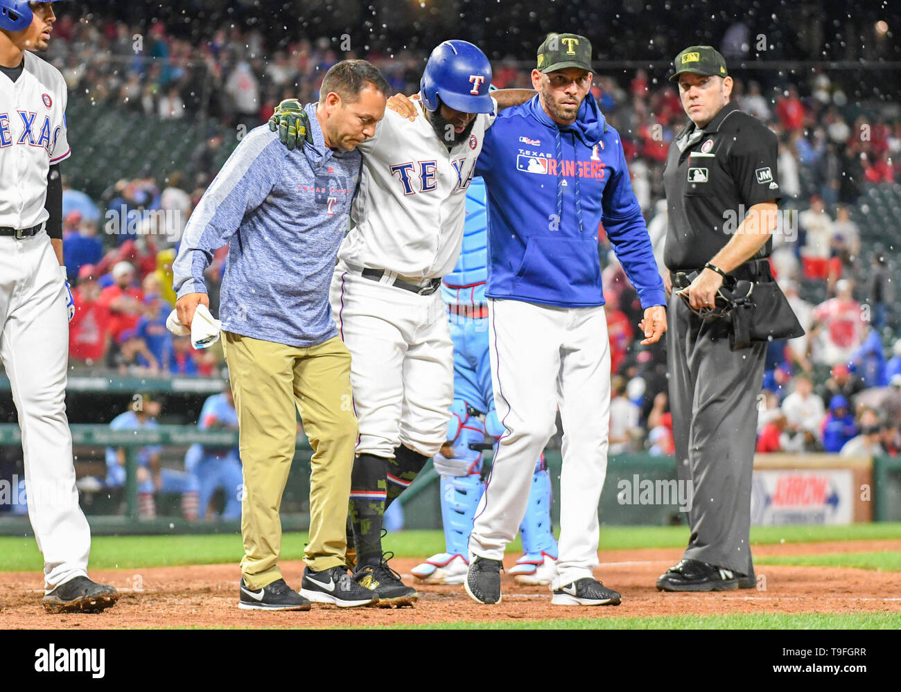 Arlington, USA. 18th May, 2019. Texas Rangers batter Danny Santana #38 is helped off the field after being hit in the lower leg by a pitch in the bottom of the ninth inning during an interleague MLB game between the St. Louis Cardinals and the Texas Rangers at Globe Life Park in Arlington, USA. Louis defeated Texas 8-2 Albert Pena/CSM/Alamy Live News Stock Photo