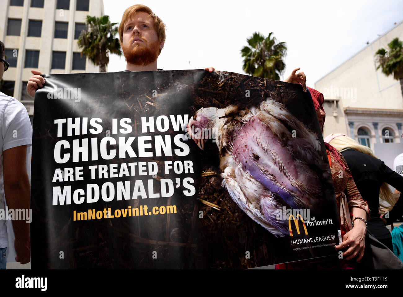 Los Angeles, USA. 18th May, 2019. An animal rights activist seen holding a  banner during a protest of what they called, animal cruelty in the chicken  supply chain of McDonald's. The protest