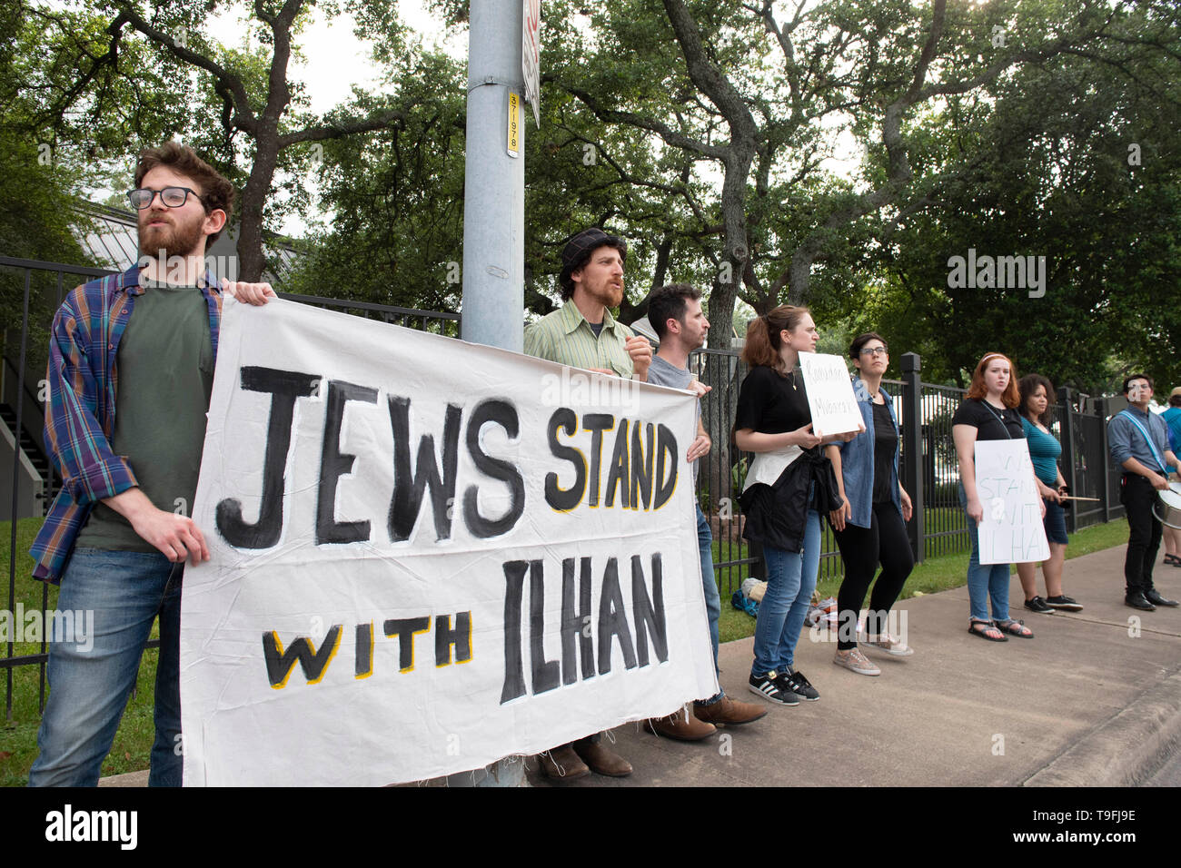 Supporters of controversial Congresswoman Ilhan Omar of Minnesota counter-demonstrate against anti-Muslim protesters as she spoke at Austin's annual city-wide iftar dinner in honor of the 14th day of Ramadan. Omar is one of two Muslims serving in the United State Congress. Stock Photo
