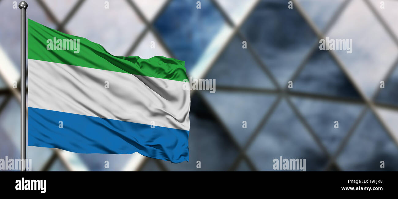 Sierra Leone flag waving in the wind against blurred modern building ...