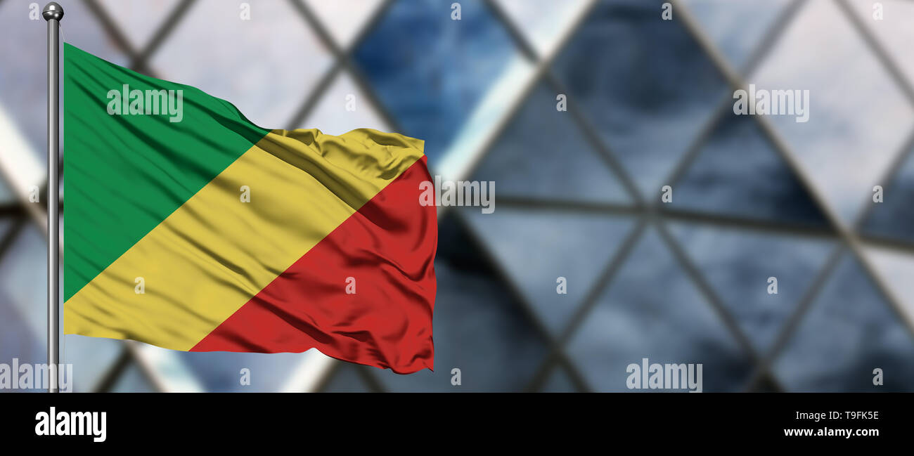 Republic Of The Congo flag waving in the wind against blurred modern ...