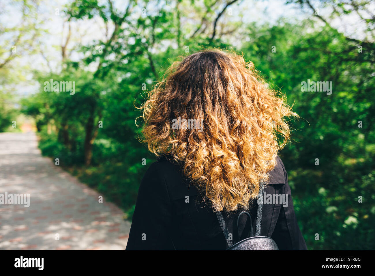 Back View Young Woman With Thick Natural Brown Curly Hair Walking