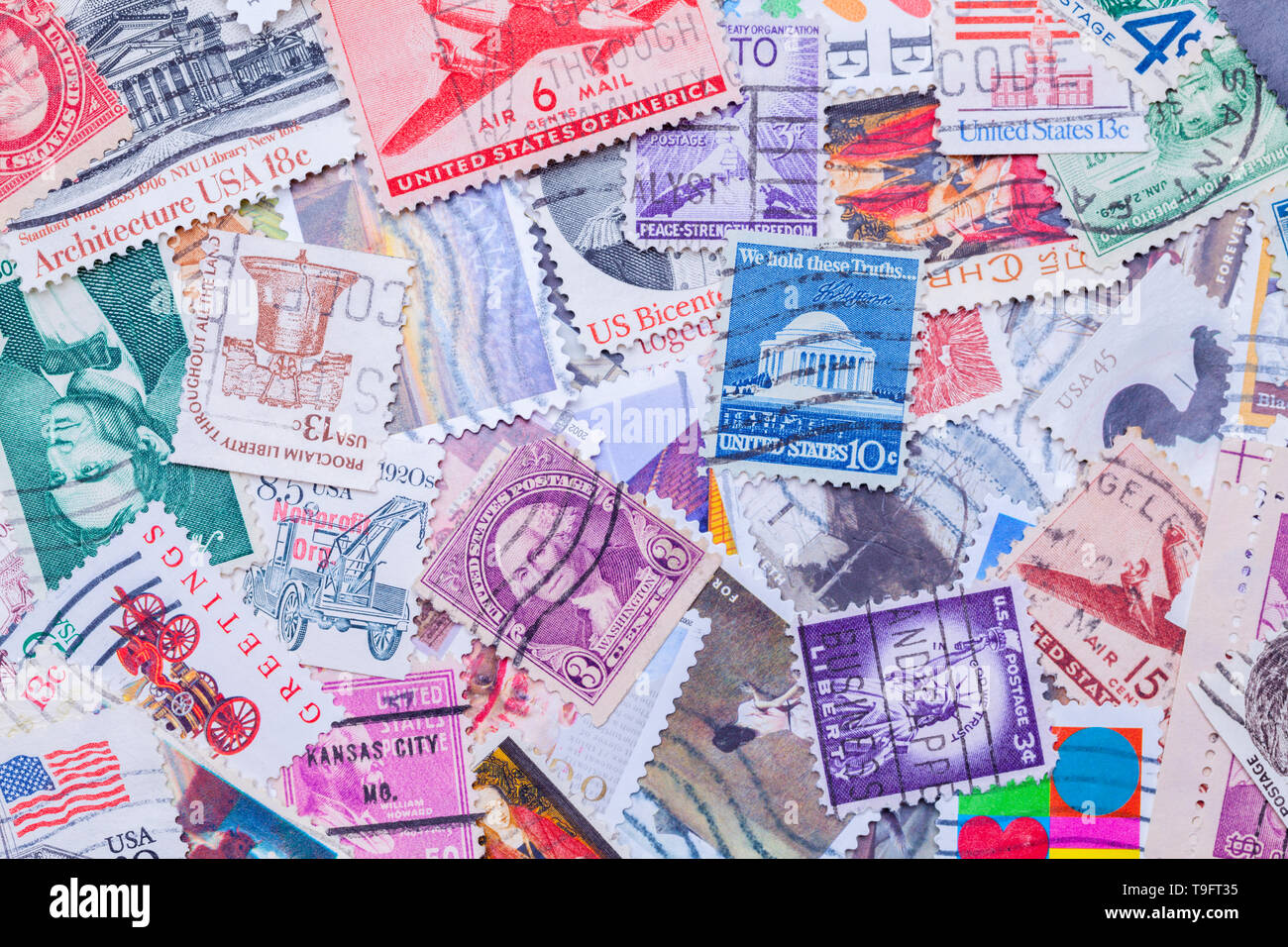 Old Used United States Postage Stamps in a Pile Background. Stock Photo