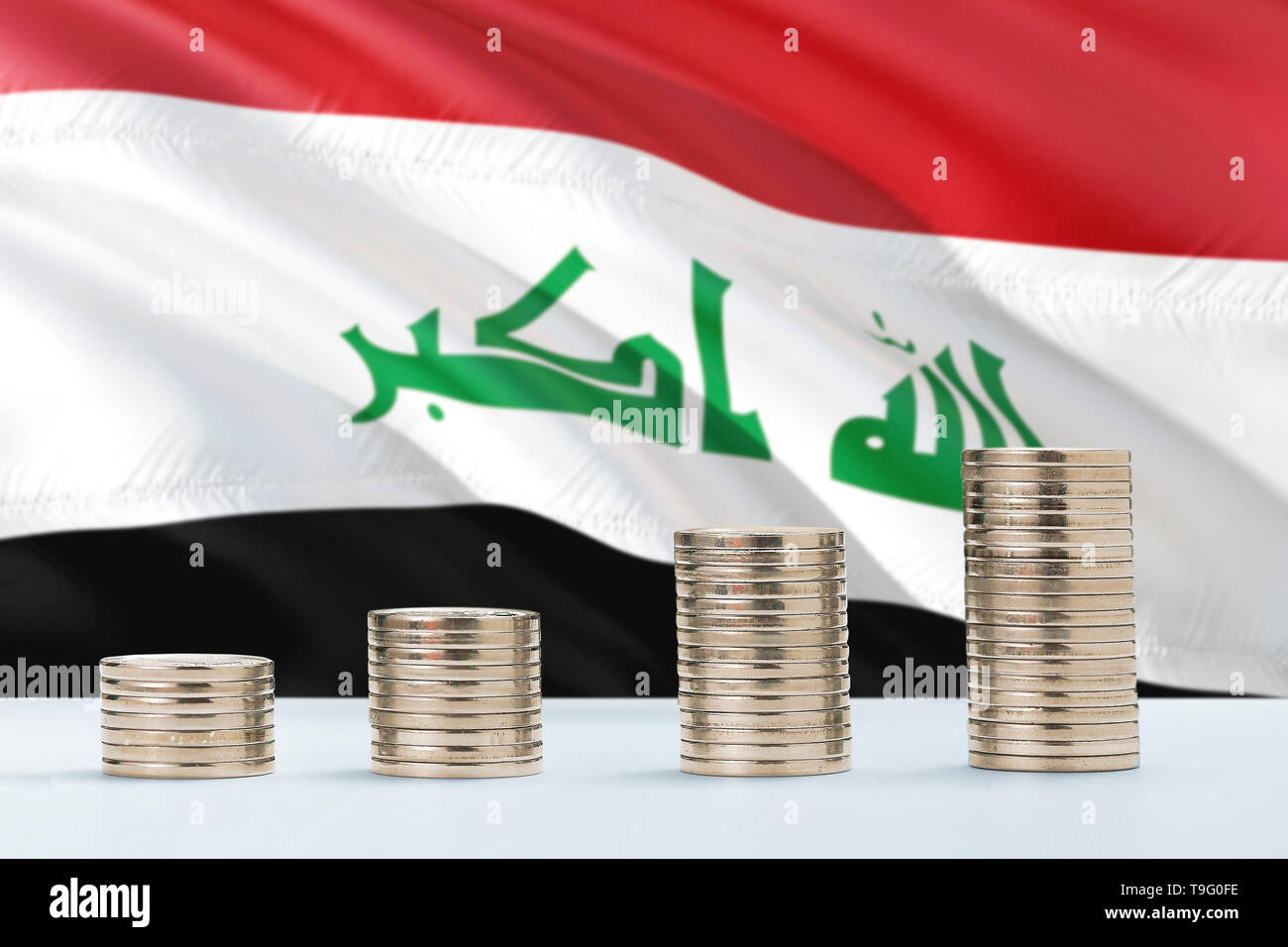 Iraq flag waving in the background with rows of coins for finance and business concept. Saving money. Stock Photo