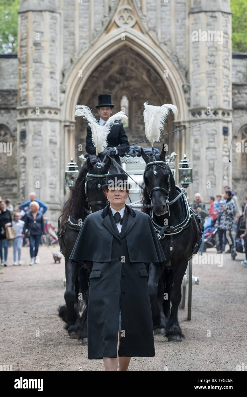 London, UK. 19th May, 2019. A horse drawn funeral coach is rode during