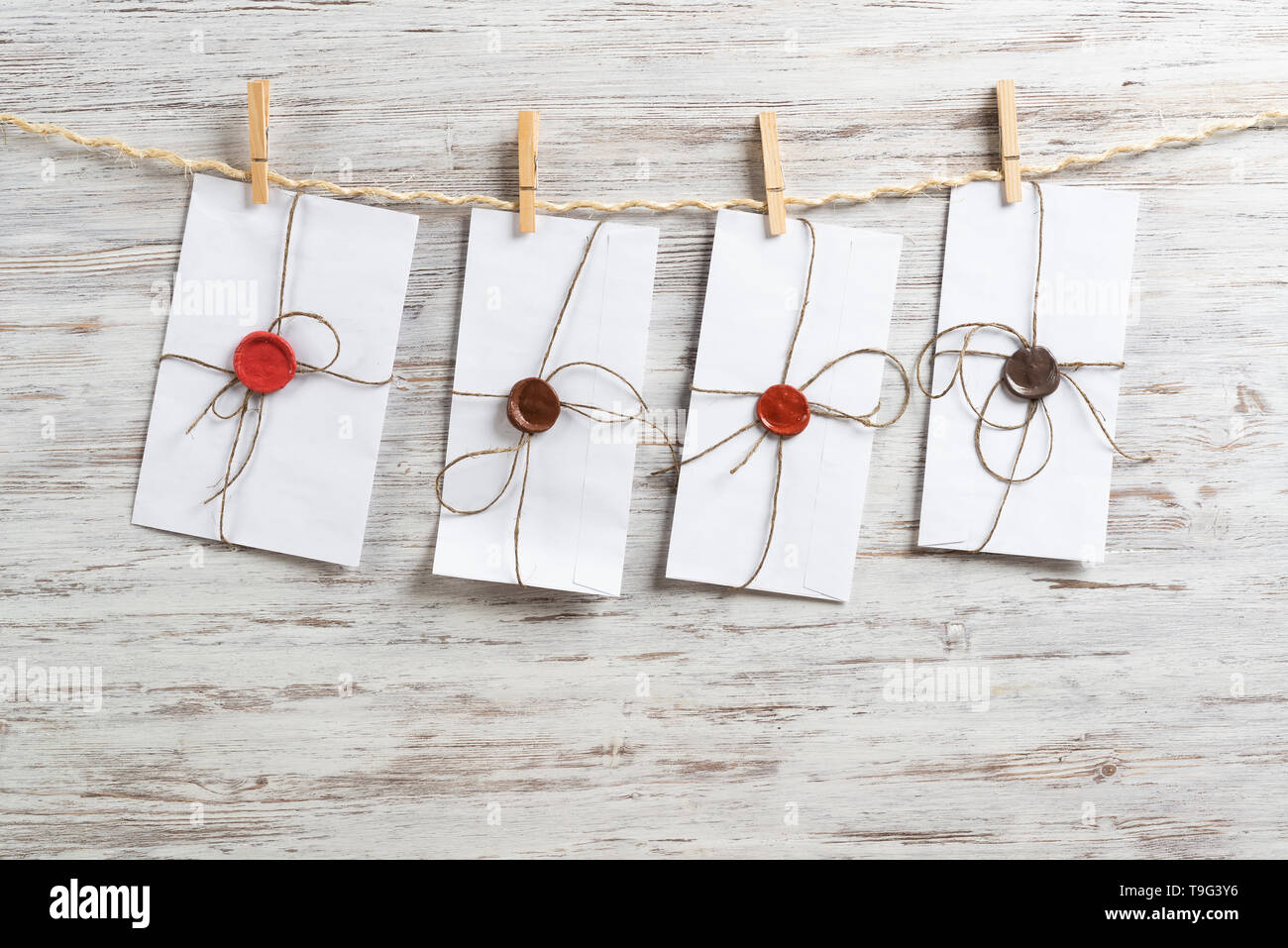 White envelopes hanging on rope Stock Photo