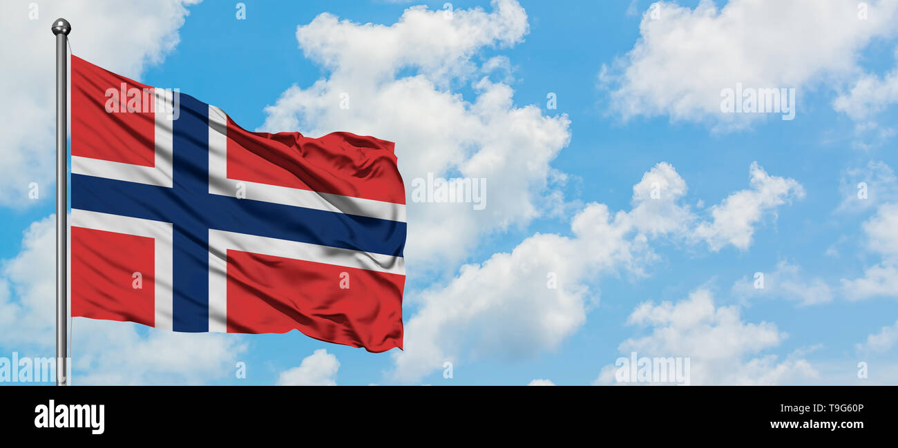 Norway flag waving in the wind against white cloudy blue sky. Diplomacy ...