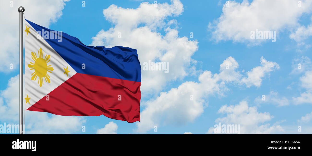 Philippines flag waving in the wind against white cloudy blue sky ...