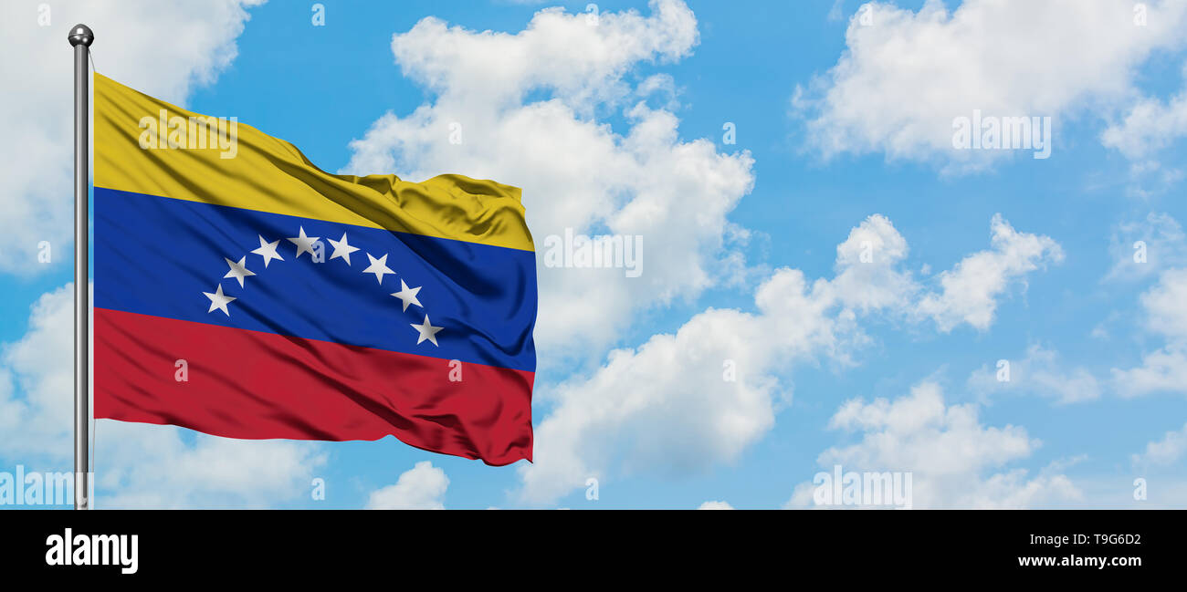 Venezuela flag waving in the wind against white cloudy blue sky ...