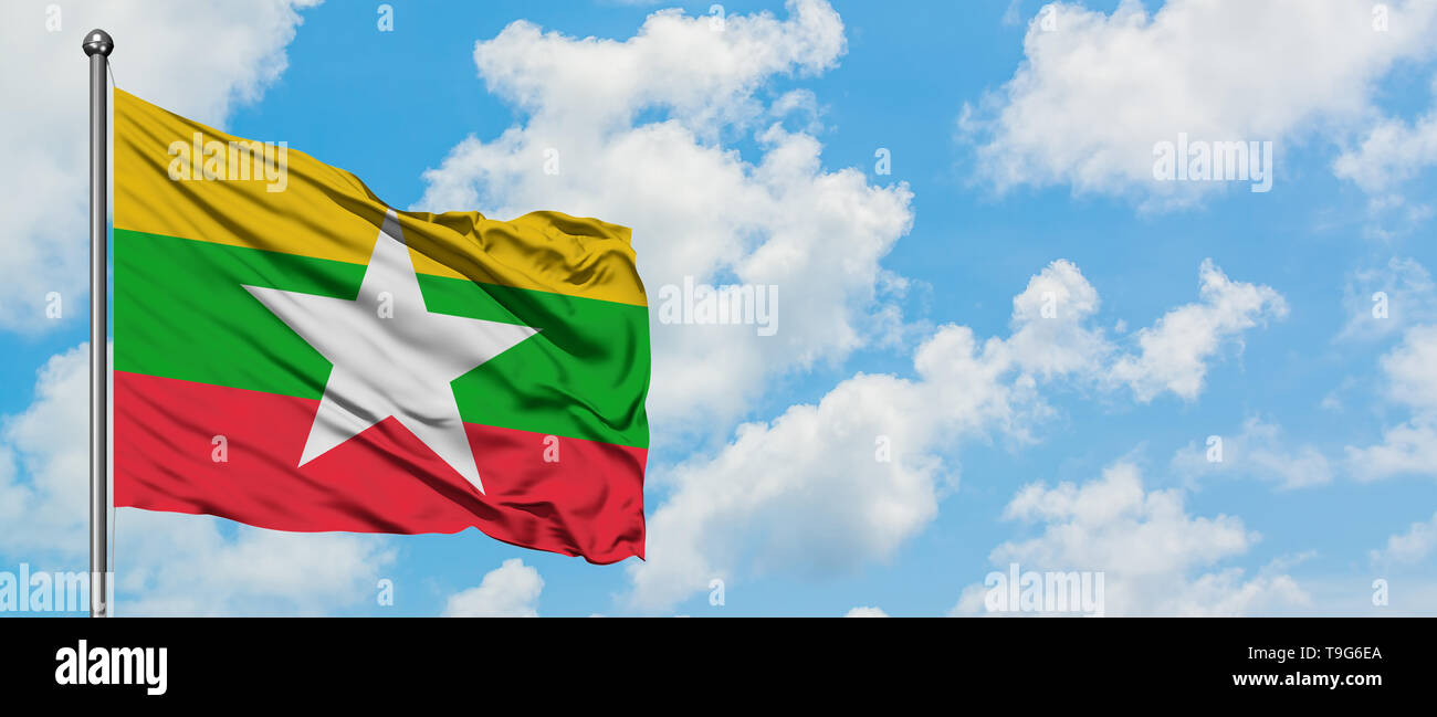 Myanmar flag waving in the wind against white cloudy blue sky ...