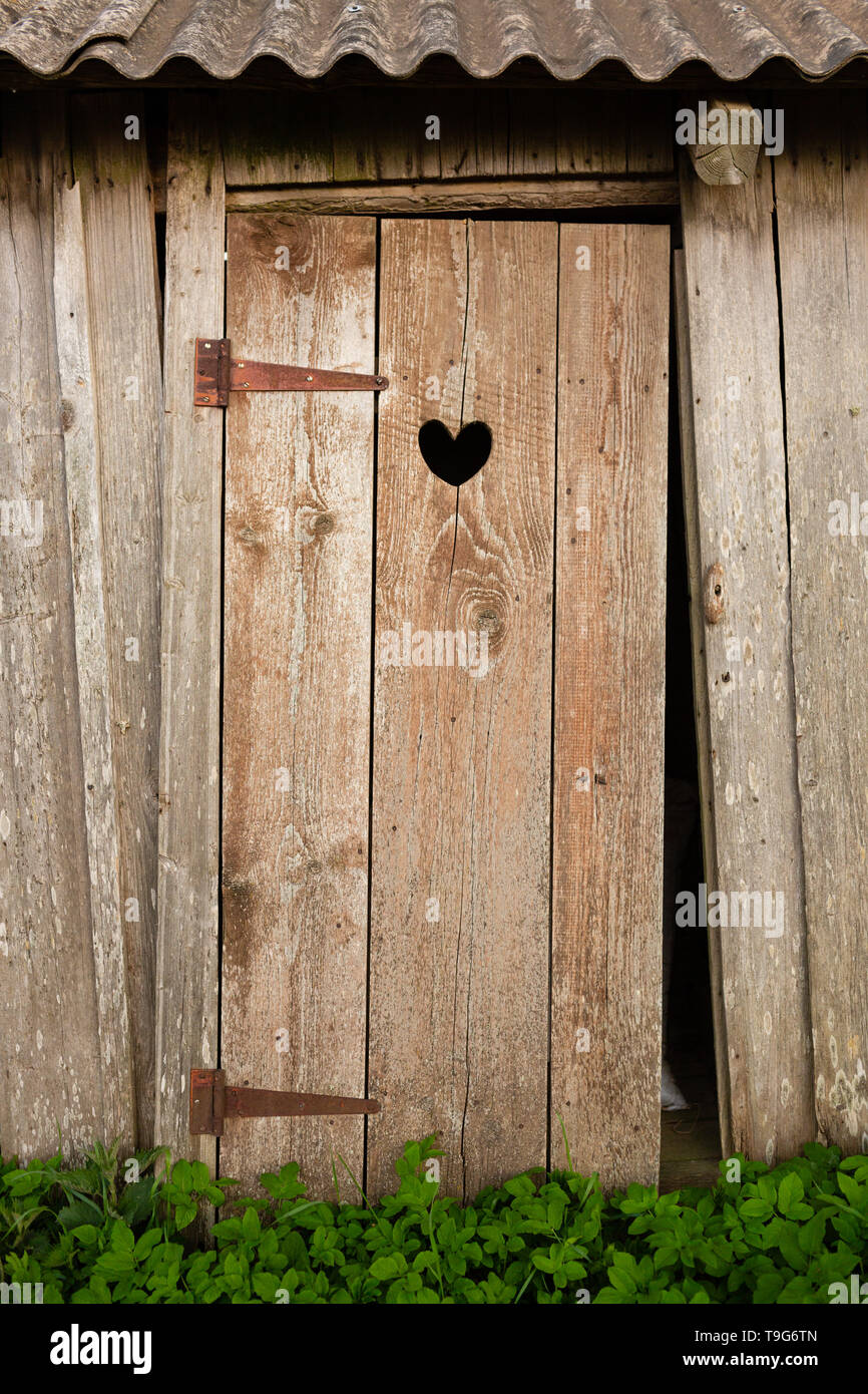 Wooden doors with heart shaped hole in it Stock Photo Alamy